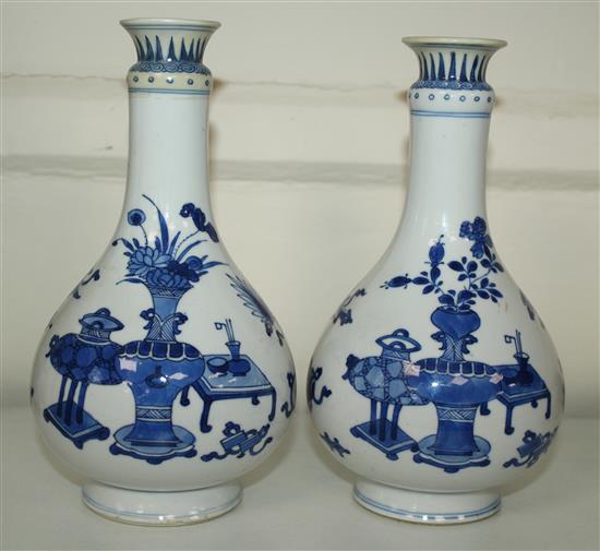 A pair of Chinese blue and white bottle vases, Kangxi period, 19.5cm, rims restored